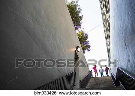 Stock Photograph - Runners standing at top of urban staircase. Fotosearch