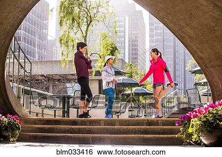 Runners stretching in urban park View Large Photo Image Stock Photograph - Runners stretching in urban park. Fotosearch