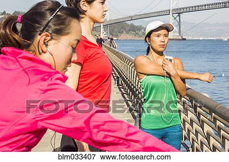 Runners stretching on urban bridge, San Francisco, California, United States View Large Photo Image Stock Photo - Runners stretching on urban bridge, San Francisco, California, United States. Fotosearch