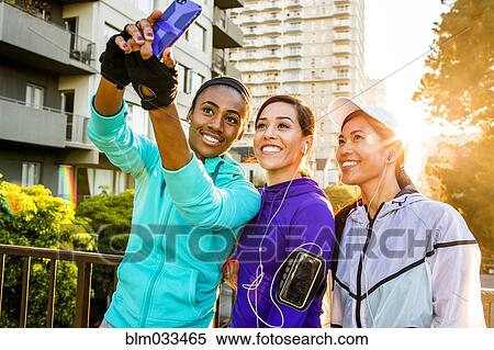 Runners taking selfie in city View Large Photo Image Stock Photography - Runners taking selfie in city. Fotosearch