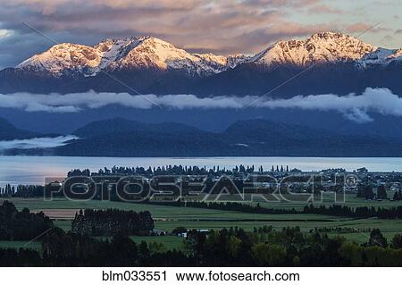 Snowcapped mountains in rural landscape, Te Anau, Southland, New Zealand View Large Photo Image Stock Image - Snowcapped mountains in rural landscape, Te Anau, Southland, New Zealand. Fotosearch