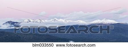Snowcapped mountains under sunset sky, Te Anau, Southland, New Zealand View Large Photo Image Stock Image - Snowcapped mountains under sunset sky, Te Anau, Southland, New Zealand. Fotosearch