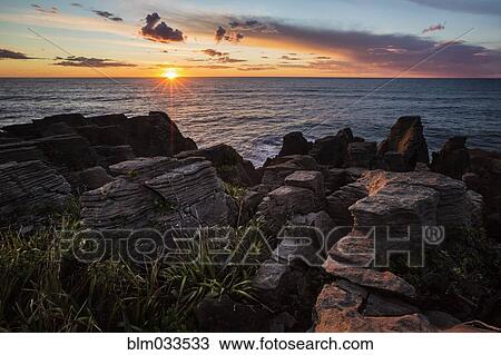 Sunset over rocky coastline and ocean View Large Photo Image Stock Image - Sunset over rocky coastline and ocean. Fotosearch
