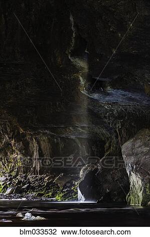 Water flowing through rocky ocean cave View Large Photo Image Stock Image - Water flowing through rocky ocean cave. Fotosearch