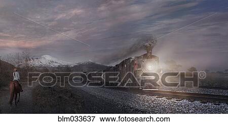 Woman on horse watching train in remote landscape View Large Photo Image Stock Photo - Woman on horse watching train in remote landscape. Fotosearch