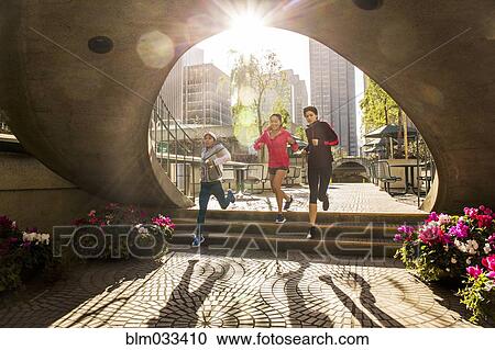 Stock Image - Women running in urban park. Fotosearch