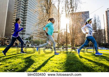 Stock Image - Women running in urban park. Fotosearch