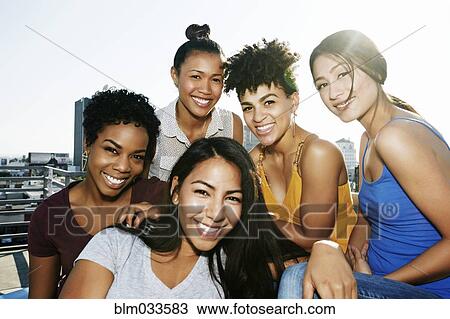 Women smiling on urban rooftop View Large Photo Image Stock Image - Women smiling on urban rooftop. Fotosearch