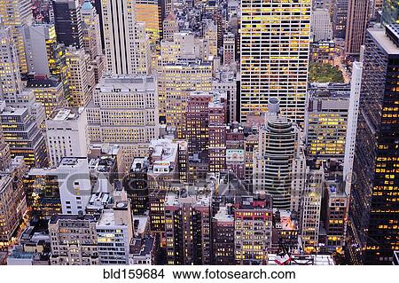 Picture - Aerial view of highrise buildings in cityscape at twilight. Fotosearch