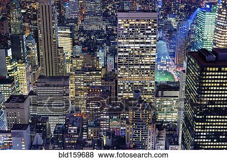 Stock Photo - Aerial view of highrise buildings in cityscape at twilight. Fotosearch