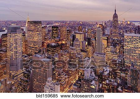 Stock Photography - Aerial view of highrise buildings in cityscape at twilight. Fotosearch