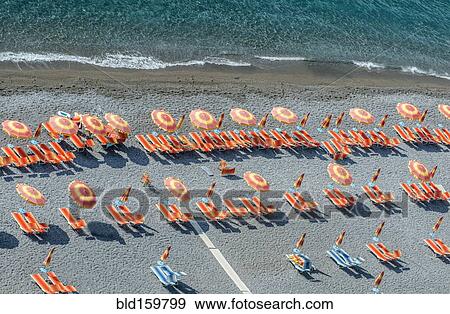 Stock Photo - Aerial view of lawn chairs and umbrellas on beach. Fotosearch