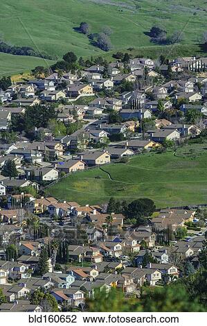 Stock Image - Aerial view of suburban neighborhood in rolling landscape. Fotosearch