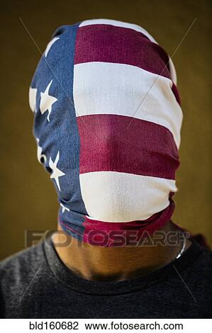 Stock Image - American flag covering face of mixed race man. Fotosearch