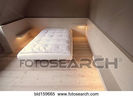 Stock Photography - Bare mattress and empty shelves in modern bedroom. Fotosearch