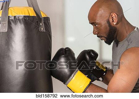 Black boxer training with punching bag View Large Photo Image Stock Image - Black boxer training with punching bag. Fotosearch