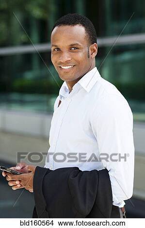 Black businessman smiling outdoors View Large Photo Image Picture - Black businessman smiling outdoors. Fotosearch
