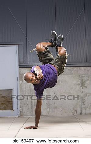Black dancer balancing on hand View Large Photo Image Stock Photo - Black dancer balancing on hand. Fotosearch