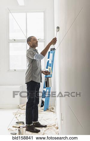 Black man painting wall of home View Large Photo Image Stock Image - Black man painting wall of home. Fotosearch