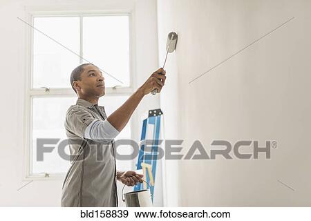 Black man painting wall of home View Large Photo Image Stock Photo - Black man painting wall of home. Fotosearch