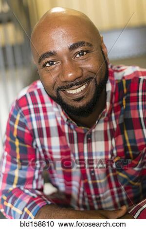 Stock Image - Black man sitting on stairs. Fotosearch