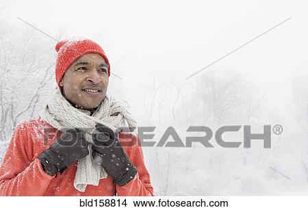 Black man wearing gloves and scarf in snow View Large Photo Image Picture - Black man wearing gloves and scarf in snow. Fotosearch