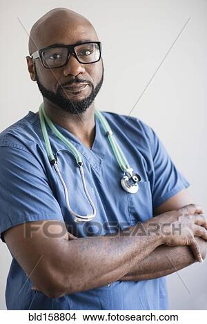 Black nurse standing with arms crossed View Large Photo Image Picture - Black nurse standing with arms crossed. Fotosearch