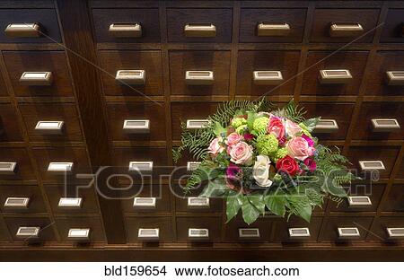 Bouquet of flowers near apothecary drawers View Large Photo Image Picture - Bouquet of flowers near apothecary drawers. Fotosearch