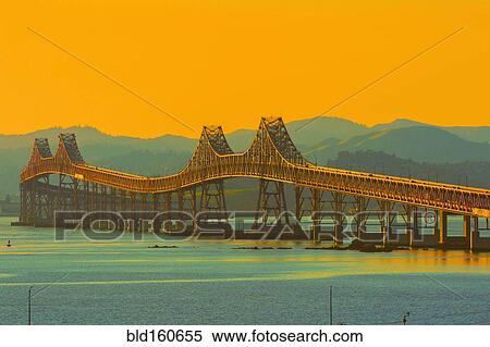 Stock Photography - Bridge and river under sunset sky, Richmond, California, United States. Fotosearch