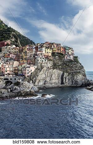 Buildings on rocky Manarola coastline and ocean, La Spezia, Italy View Large Photo Image Stock Photo - Buildings on rocky Manarola coastline and ocean, La Spezia, Italy. Fotosearch