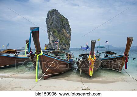 Stock Photograph - Canoes docked on beach. Fotosearch