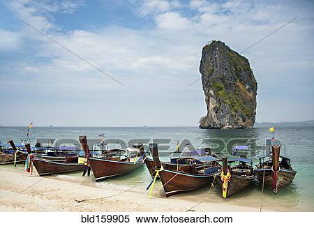 Canoes on sandy beach under cloudy sky View Large Photo Image Stock Photography - Canoes on sandy beach under cloudy sky. Fotosearch