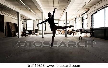 Stock Photo - Caucasian ballet dancer performing in loft. Fotosearch