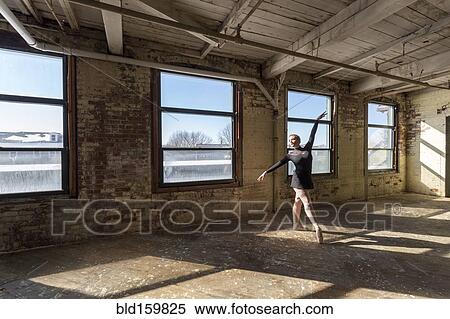 Caucasian ballet dancer performing in sunny loft View Large Photo Image Stock Photography - Caucasian ballet dancer performing in sunny loft. Fotosearch