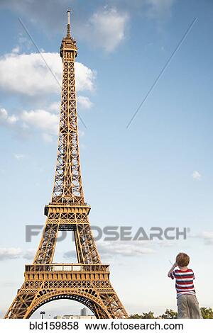 Caucasian boy admiring Eiffel Tower under blue sky, Paris, Ile-de-France, France View Large Photo Image Stock Photo - Caucasian boy admiring Eiffel Tower under blue sky, Paris, Ile-de-France, France. Fotosearch