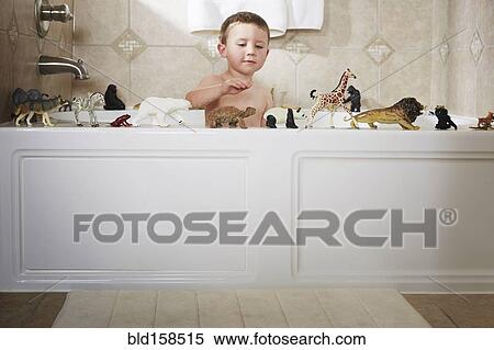 Stock Photography - Caucasian boy playing in bathtub. Fotosearch