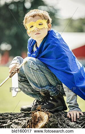 Stock Photo - Caucasian boy wearing costume and playing with sword. Fotosearch