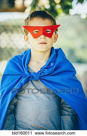 Stock Image - Caucasian boy wearing superhero costume. Fotosearch