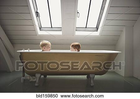 Caucasian brothers sitting in bathtub View Large Photo Image Stock Image - Caucasian brothers sitting in bathtub. Fotosearch