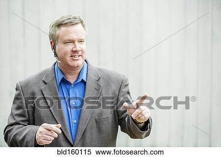 Stock Photography - Caucasian businessman talking on headset. Fotosearch