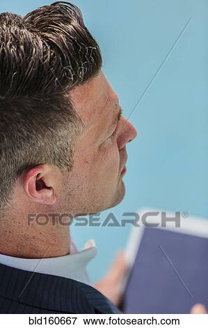 Stock Photo - Caucasian businessman using digital tablet. Fotosearch