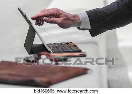 Stock Photography - Caucasian businessman using digital tablet. Fotosearch