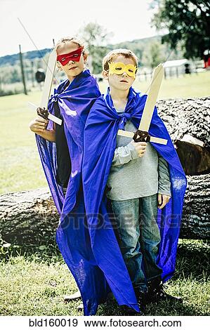 Caucasian children in costumes playing with swords View Large Photo Image Stock Photo - Caucasian children in costumes playing with swords. Fotosearch
