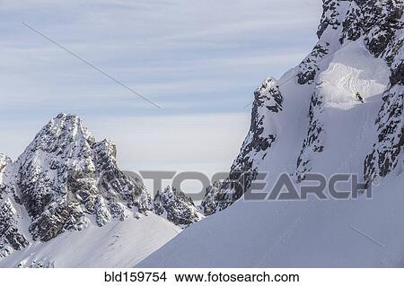 Picture - Caucasian climber scaling snowy mountain slope. Fotosearch