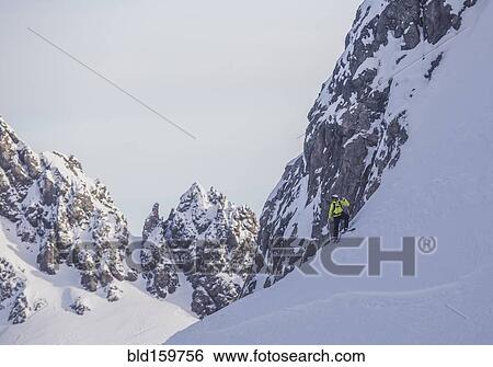 Caucasian climber standing on snowy mountain slope View Large Photo Image Stock Photograph - Caucasian climber standing on snowy mountain slope. Fotosearch