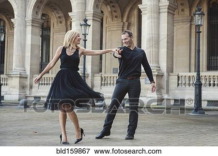 Caucasian couple dancing in courtyard View Large Photo Image Stock Photo - Caucasian couple dancing in courtyard. Fotosearch
