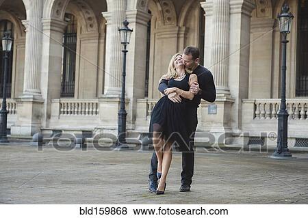 Caucasian couple dancing in courtyard View Large Photo Image Stock Photo - Caucasian couple dancing in courtyard. Fotosearch
