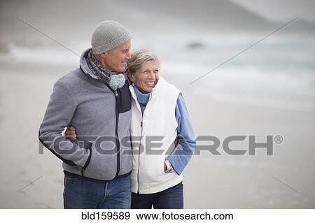 Caucasian couple hugging on beach View Large Photo Image Stock Photo - Caucasian couple hugging on beach. Fotosearch