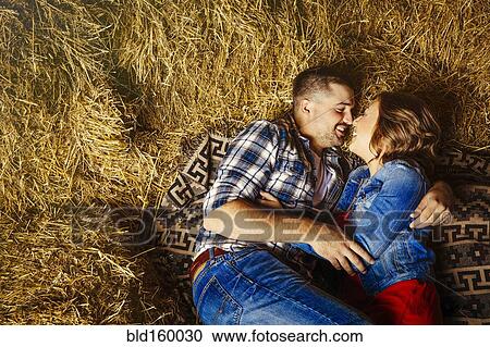 Caucasian couple kissing in haystacks View Large Photo Image Stock Image - Caucasian couple kissing in haystacks. Fotosearch