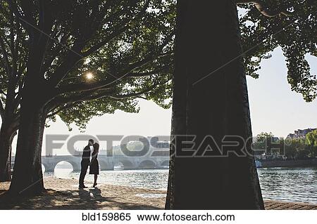 Caucasian couple kissing near bridge, Paris, Ile-de-France, France View Large Photo Image Stock Photography - Caucasian couple kissing near bridge, Paris, Ile-de-France, France. Fotosearch